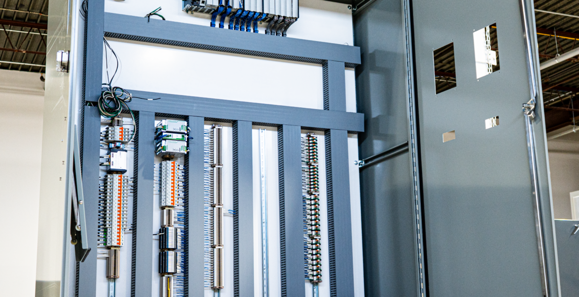 An industrial PLC control panel with well-organized wiring, neatly labeled components, and integrated automation modules designed for robust and reliable system operation.