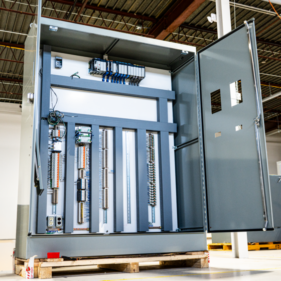 An industrial PLC control panel with well-organized wiring, neatly labeled components, and integrated automation modules designed for robust and reliable system operation.